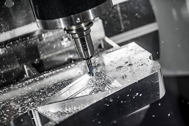 Metalworking CNC milling machine. Cutting metal modern processing technology. Small depth of field. Warning - authentic shooting in challenging conditions. A little bit grain and maybe blurred.